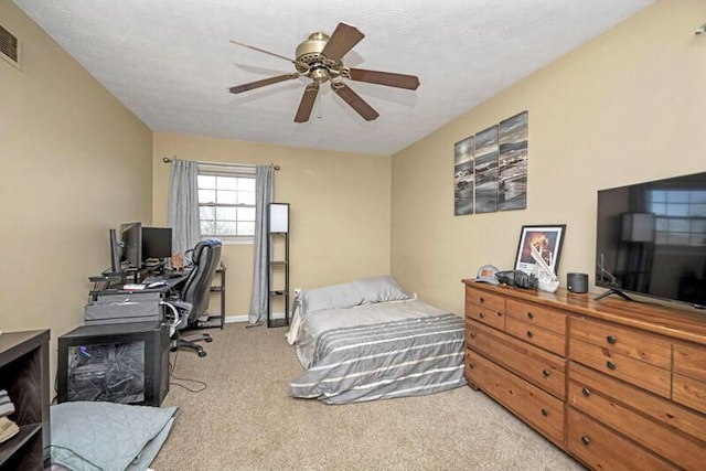 bedroom with visible vents, a ceiling fan, baseboards, and carpet floors