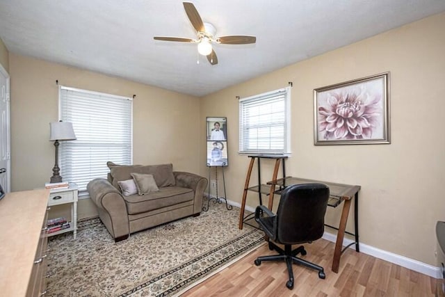 office featuring a ceiling fan, baseboards, and wood finished floors