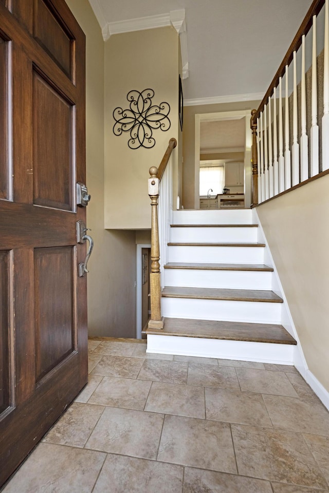 staircase with baseboards and ornamental molding