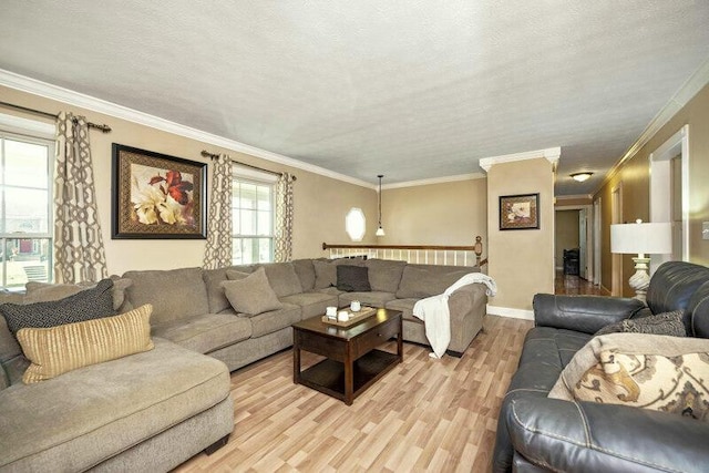 living room featuring baseboards, a textured ceiling, crown molding, and light wood finished floors