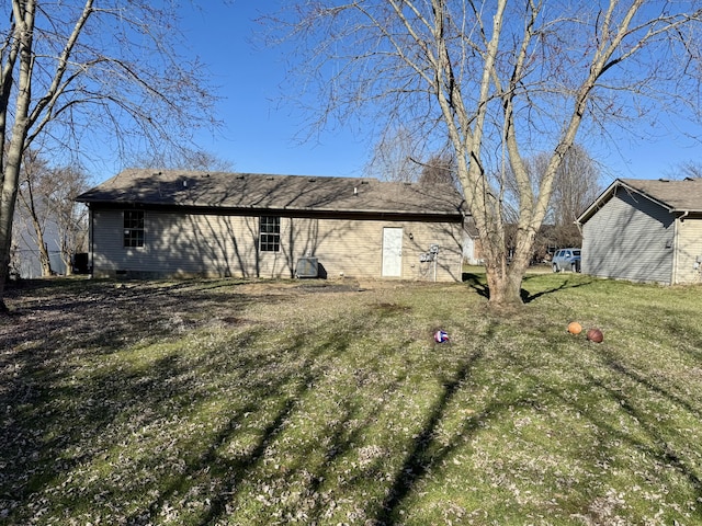 rear view of property featuring crawl space and a yard