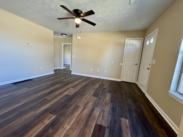 interior space featuring visible vents, baseboards, and dark wood-style flooring