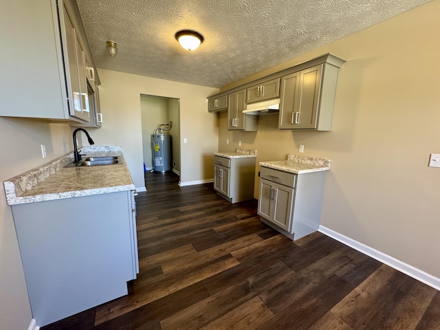 kitchen featuring a sink, gray cabinetry, dark wood finished floors, and electric water heater