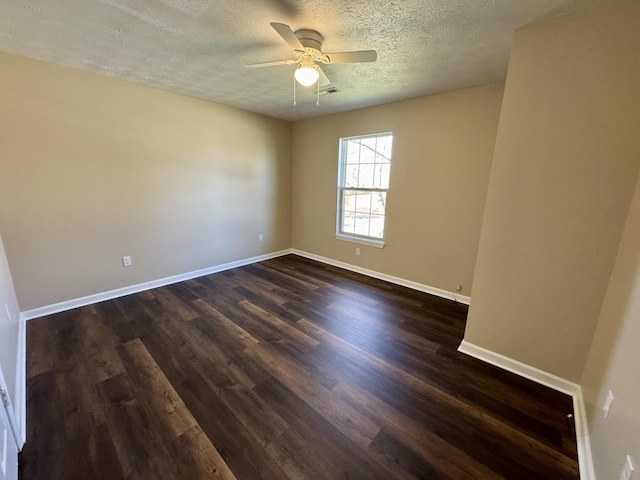 empty room with baseboards, visible vents, dark wood-style flooring, and ceiling fan