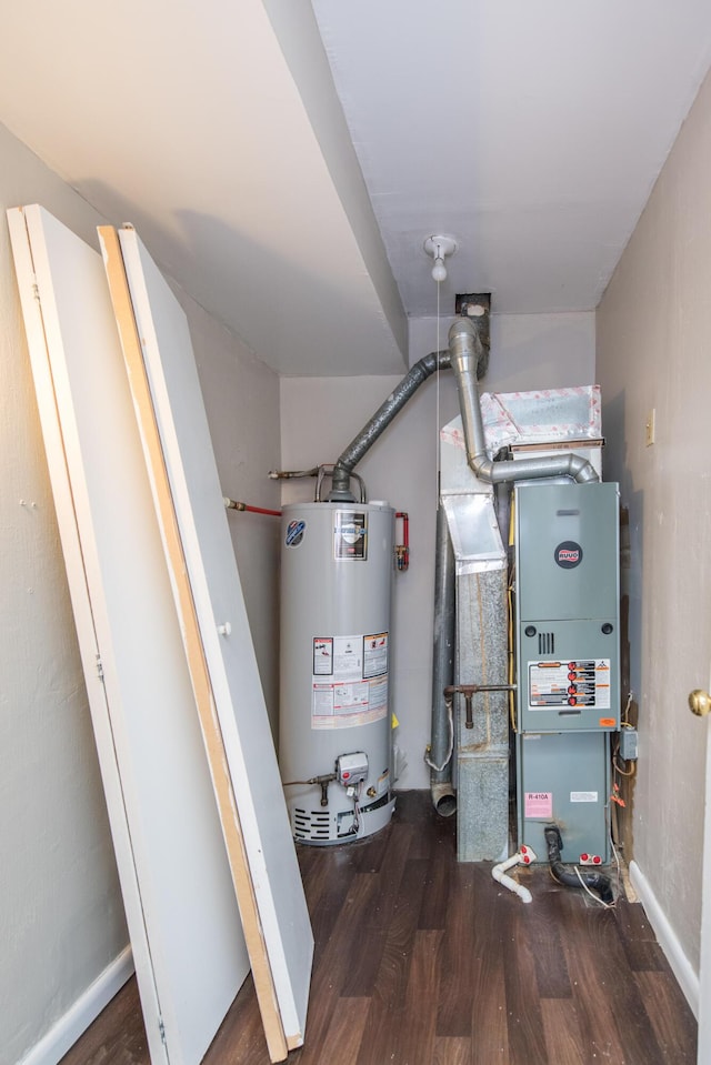 utility room with gas water heater and heating unit