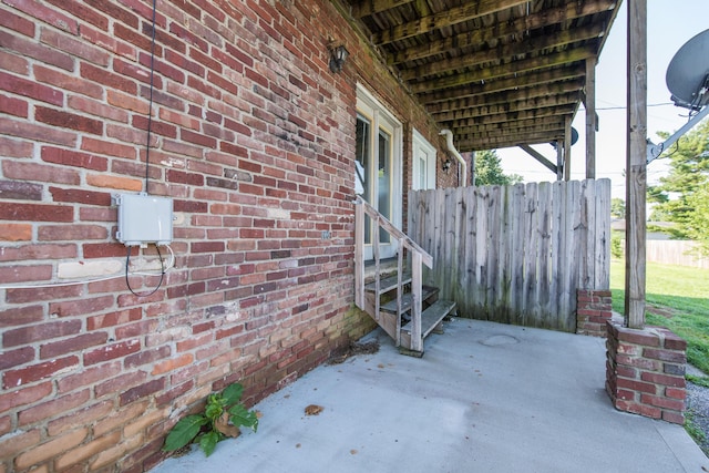 view of patio / terrace featuring entry steps and fence