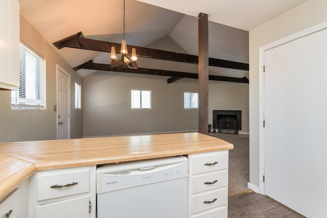 kitchen featuring dishwasher, white cabinets, a fireplace, and vaulted ceiling