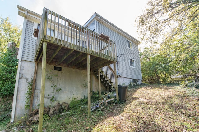 back of house with a deck and stairs