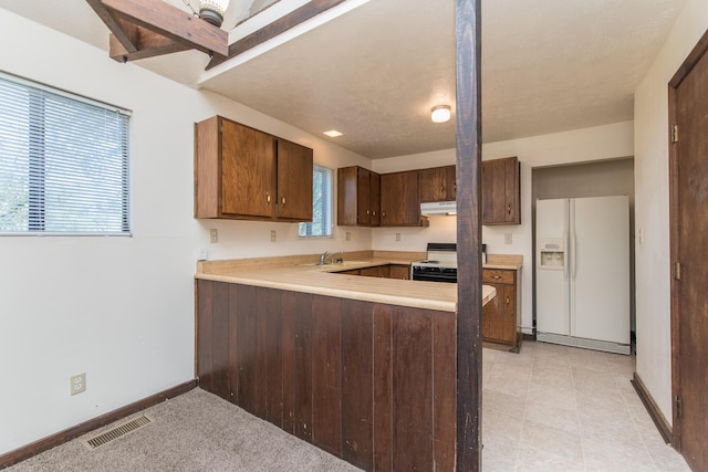 kitchen with visible vents, electric stove, under cabinet range hood, white refrigerator with ice dispenser, and light countertops