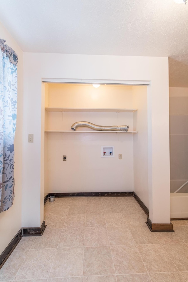 laundry area with hookup for a washing machine, light tile patterned floors, baseboards, hookup for an electric dryer, and laundry area