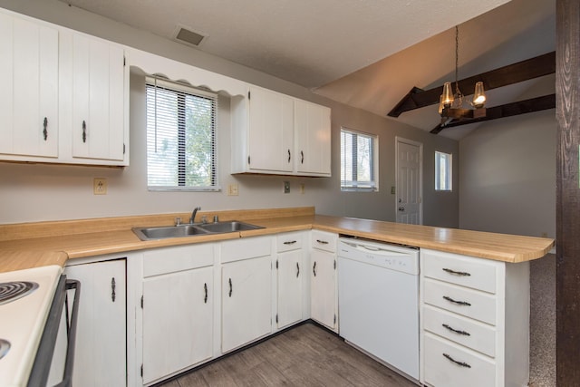 kitchen featuring dishwasher, light countertops, visible vents, and a sink