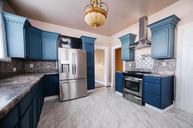 kitchen featuring blue cabinetry, marble finish floor, appliances with stainless steel finishes, and wall chimney exhaust hood