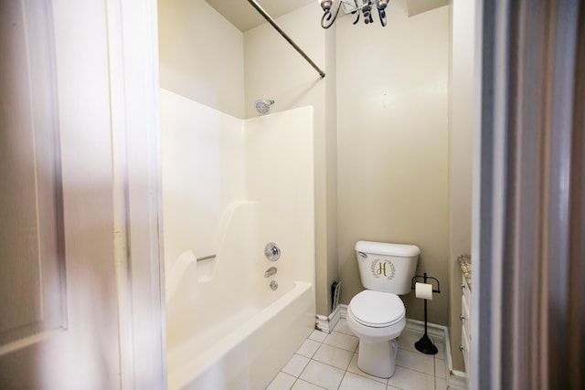 bathroom with tile patterned flooring, toilet, baseboards, and shower / bath combination