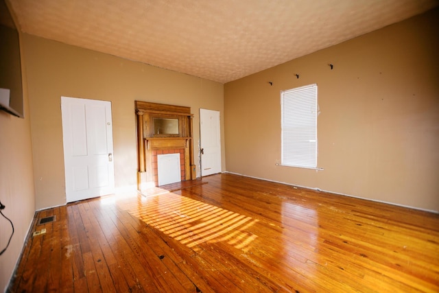 interior space with hardwood / wood-style flooring, visible vents, and a textured ceiling