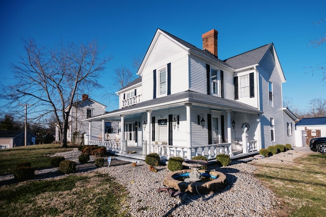 view of home's exterior featuring a porch and a chimney