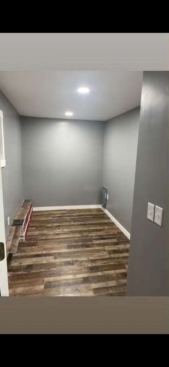 unfurnished room featuring wood finished floors and baseboards