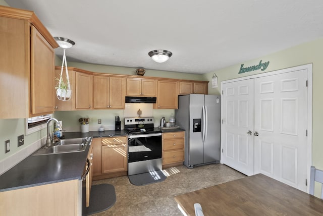 kitchen featuring a sink, dark countertops, range hood, appliances with stainless steel finishes, and hanging light fixtures