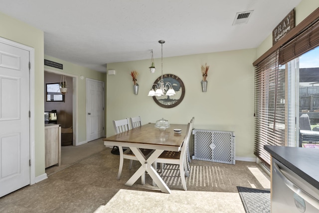 dining area with a notable chandelier, visible vents, and baseboards