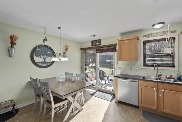 kitchen featuring baseboards, visible vents, a sink, dishwasher, and dark countertops