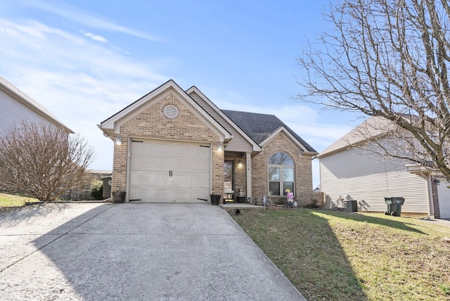 view of front of home featuring a front lawn, a garage, brick siding, and driveway