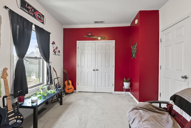 bedroom with a closet, visible vents, carpet flooring, and baseboards