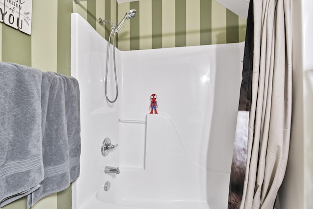 bathroom featuring shower / bath combo and wallpapered walls