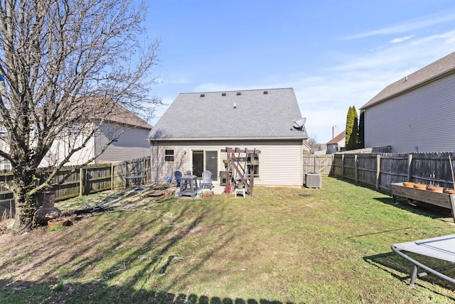 rear view of house with a shingled roof, a lawn, cooling unit, a fenced backyard, and a patio