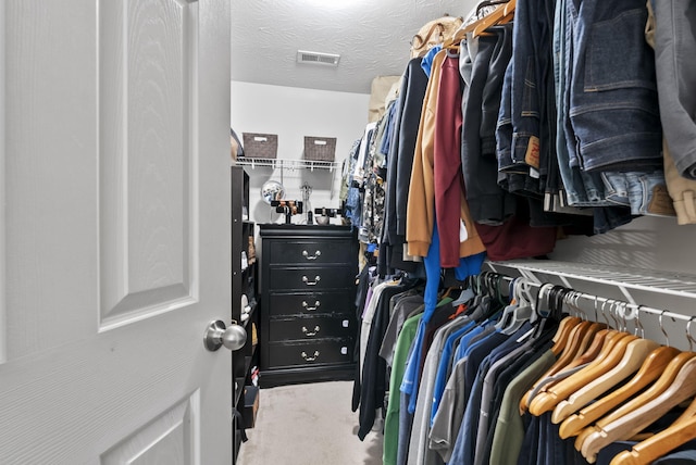 spacious closet with carpet flooring and visible vents