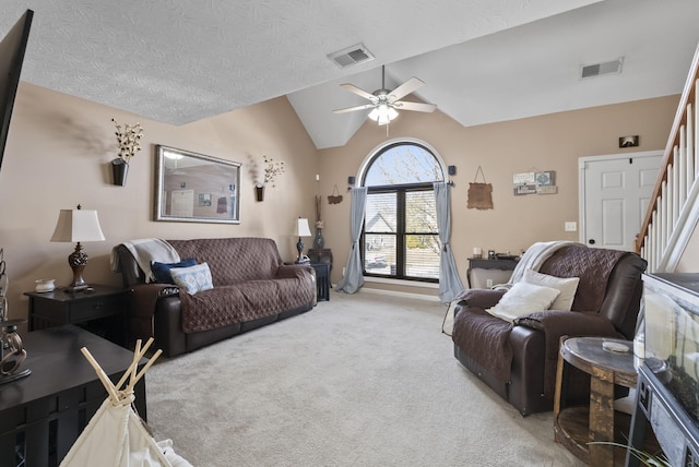 living area with visible vents, light colored carpet, stairway, and lofted ceiling