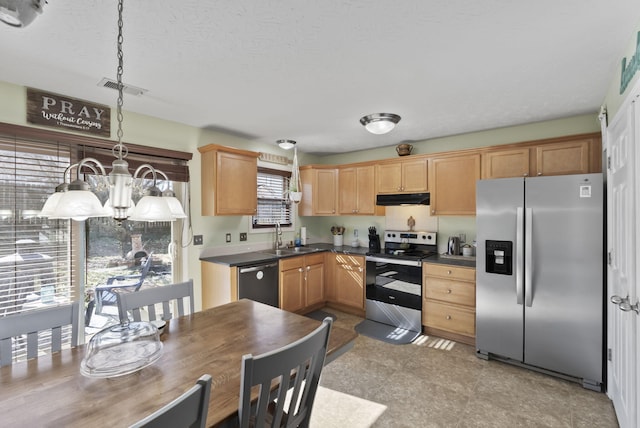 kitchen featuring visible vents, under cabinet range hood, a sink, dark countertops, and stainless steel appliances