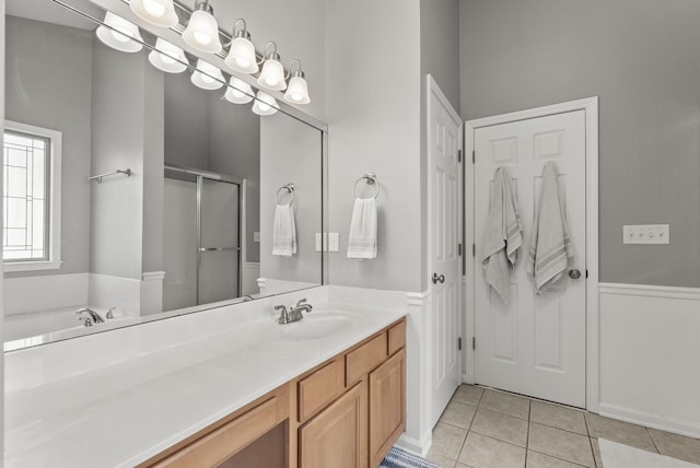 bathroom featuring tile patterned floors, a shower stall, vanity, and a bath