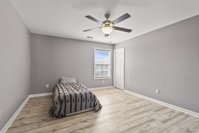 unfurnished bedroom with visible vents, ceiling fan, baseboards, and wood finished floors