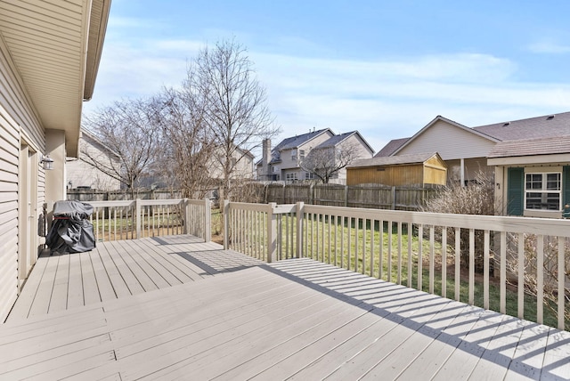 wooden terrace with a residential view and a fenced backyard