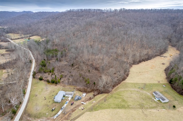 drone / aerial view featuring a forest view