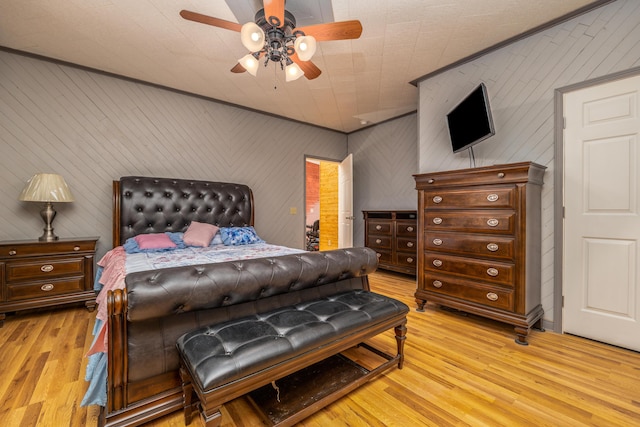 bedroom with light wood-style flooring and ceiling fan