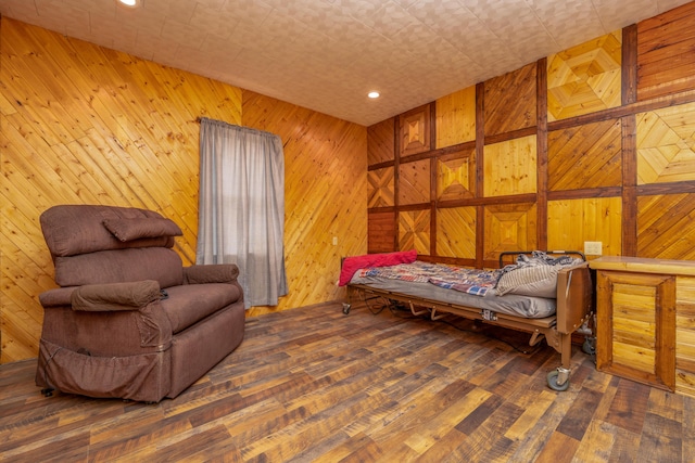 sitting room featuring hardwood / wood-style flooring, recessed lighting, and wood walls