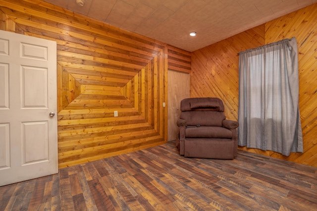 sitting room with wood finished floors and wood walls