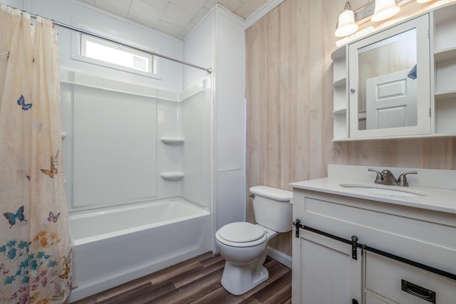 bathroom with vanity, toilet, wood finished floors, and shower / bath combo