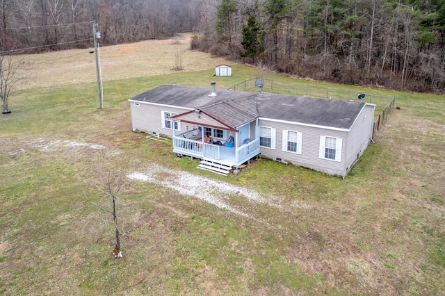 back of house featuring crawl space, covered porch, and a yard