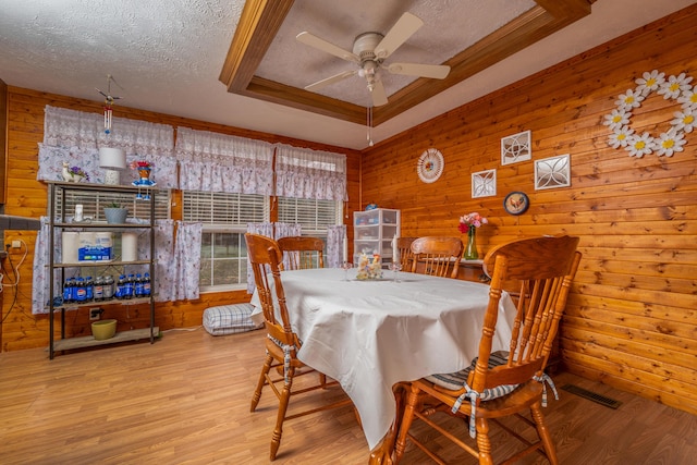 kitchen with tile countertops, decorative backsplash, light wood-style floors, black appliances, and a ceiling fan