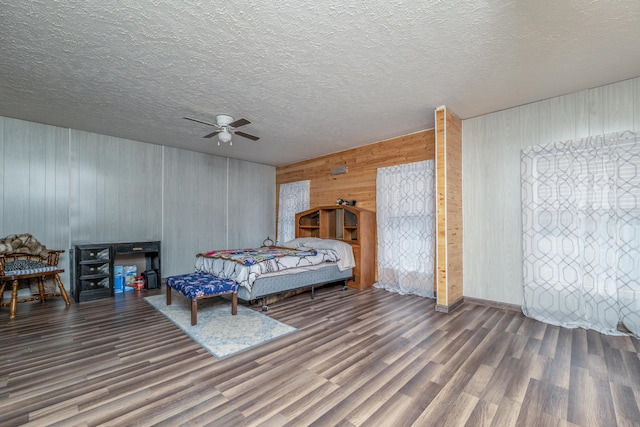 interior space with wooden ceiling, wood finished floors, a stall shower, and wood walls