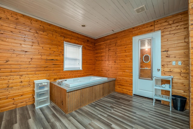 bedroom featuring ornamental molding, a textured ceiling, baseboards, and wood finished floors