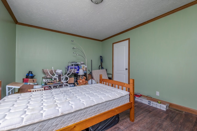 bedroom featuring baseboards, a textured ceiling, dark wood finished floors, and ornamental molding