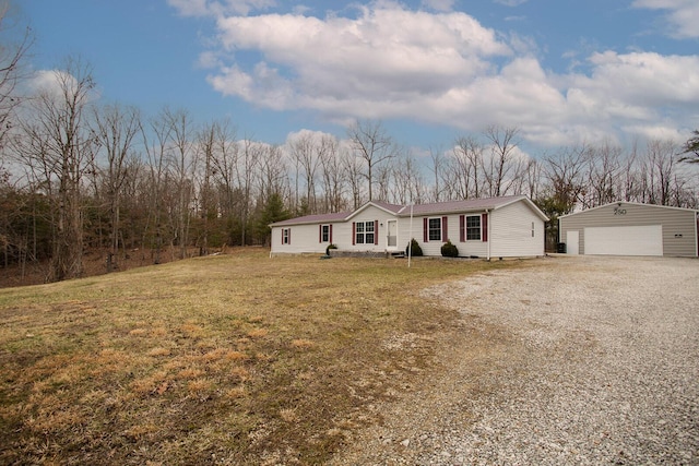 view of front of house with crawl space, a garage, an outdoor structure, and a front yard