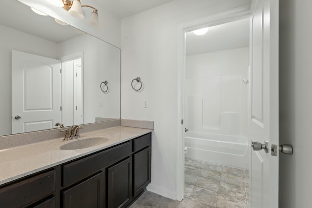 bathroom with vanity,  shower combination, toilet, and baseboards