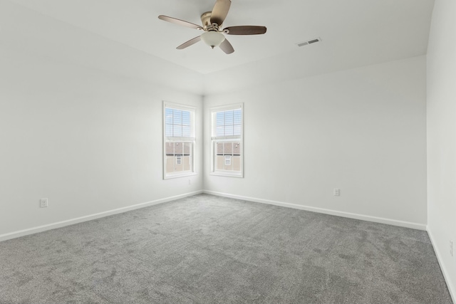 unfurnished room with a ceiling fan, carpet flooring, baseboards, and visible vents