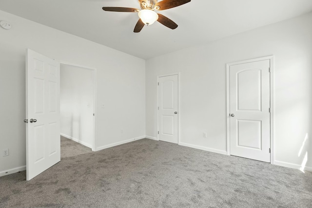 unfurnished bedroom featuring carpet flooring, a ceiling fan, and baseboards