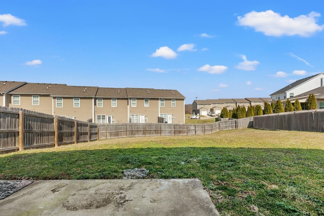 view of yard featuring a residential view and a fenced backyard