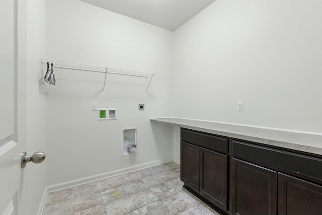 washroom featuring cabinet space, baseboards, hookup for an electric dryer, and hookup for a washing machine