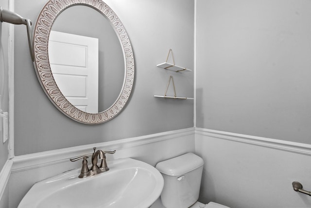 bathroom featuring toilet and a sink